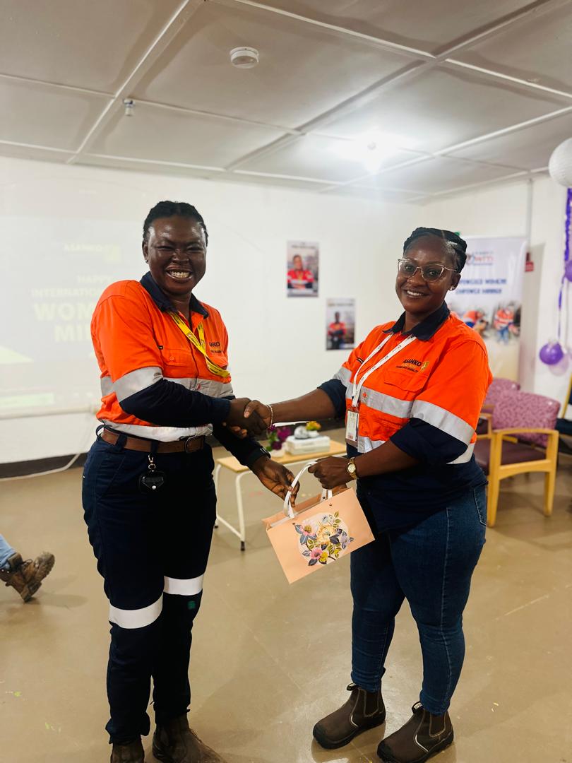 Recognition handshake at WIM celebration